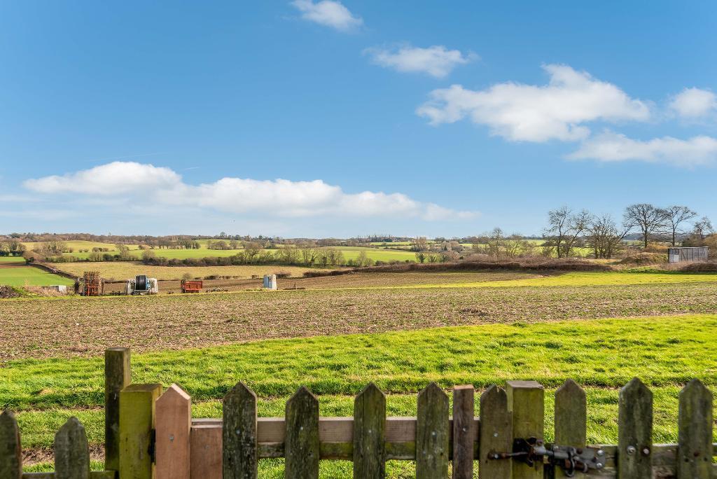 Views across farmland to rear