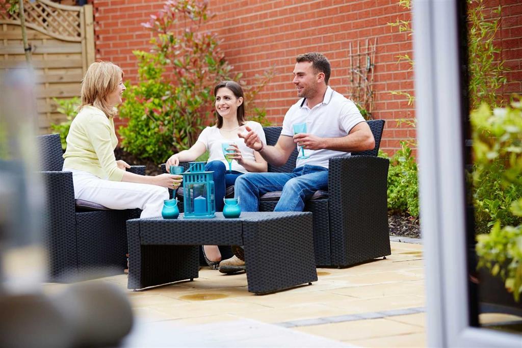 Friends enjoying a drink together in a private garden