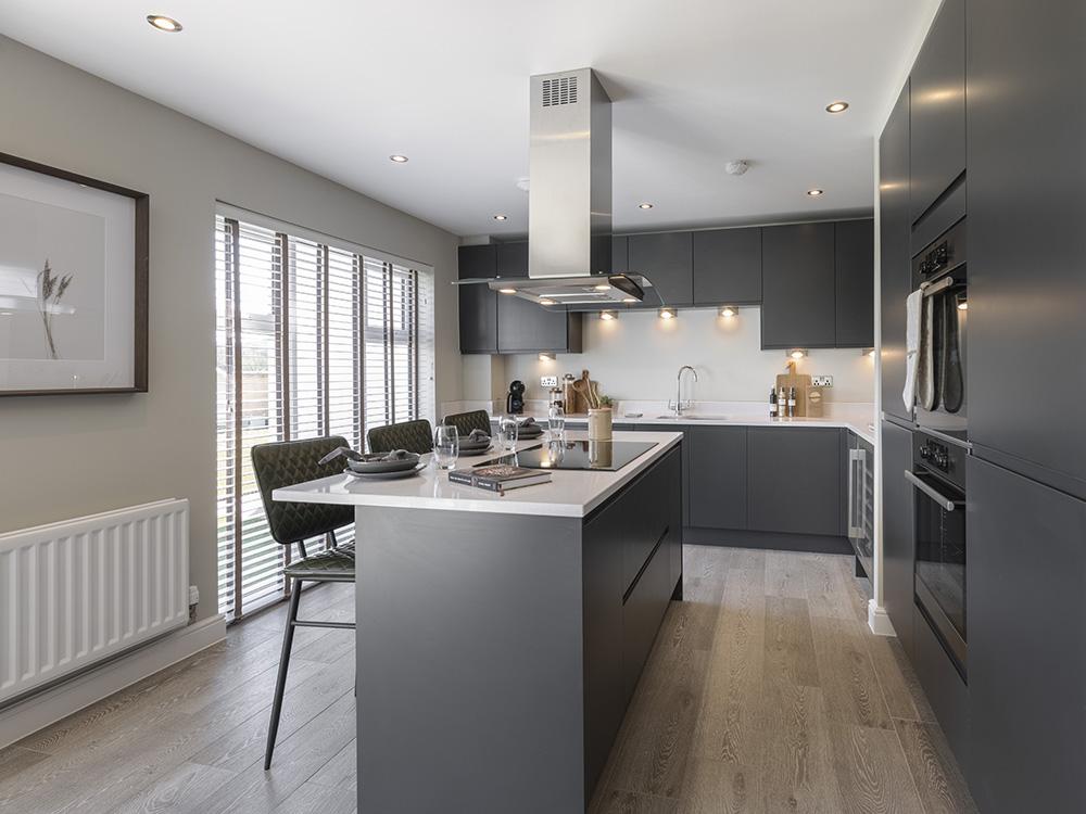 Fully fitted kitchen with a full height window and stylish island