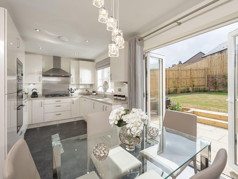 High specification kitchen with bi-fold doors leading to the garden