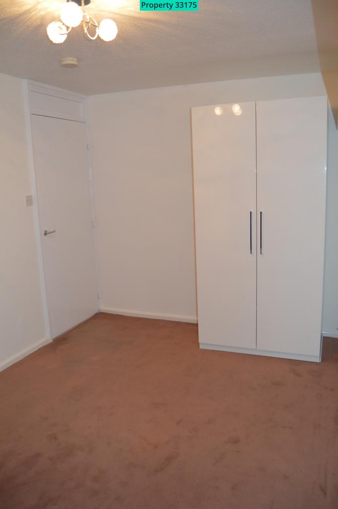 Bedroom with large wardrobe which remains