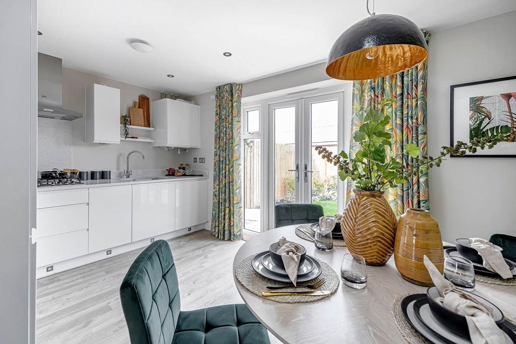 The kitchen/dining area features double doors out to the garden