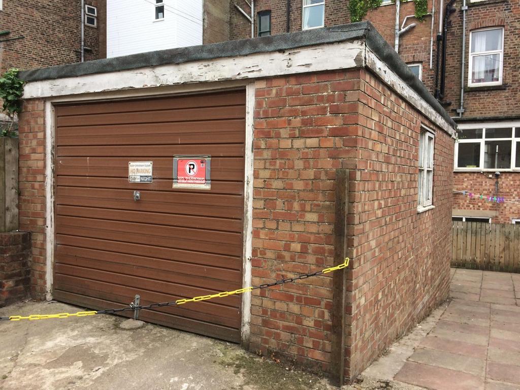 Garage and driveway and bin storage area behind