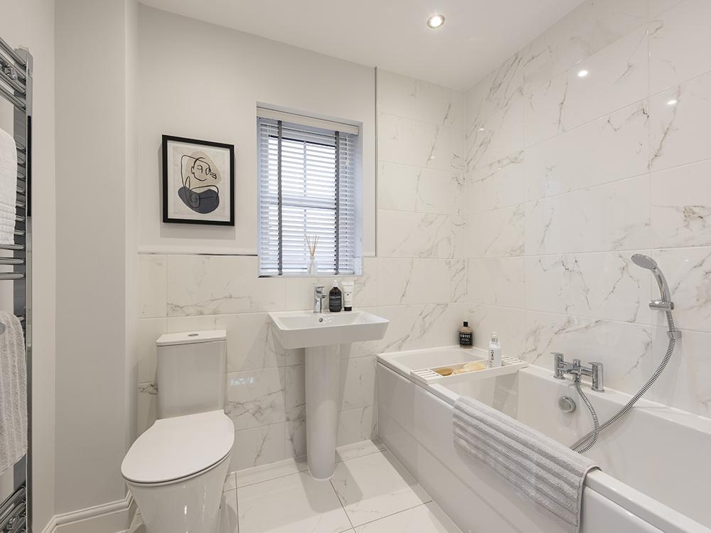 Extensively tiled family bathroom