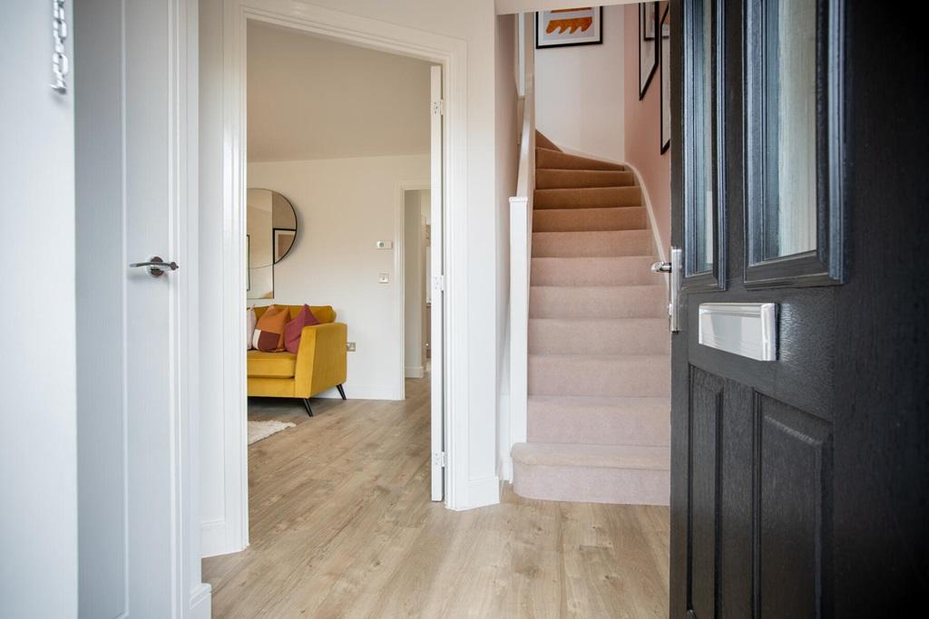 A bright hallway leads through to the lounge