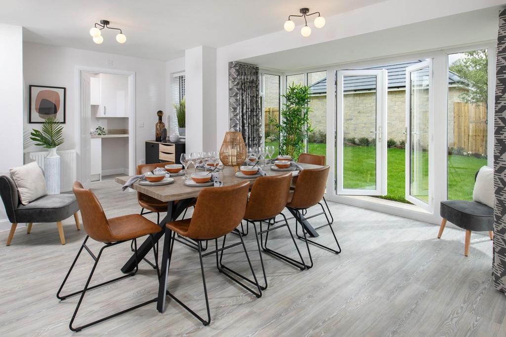 Open plan kitchen/dining area with glazed bay leading onto garden   Millford style home