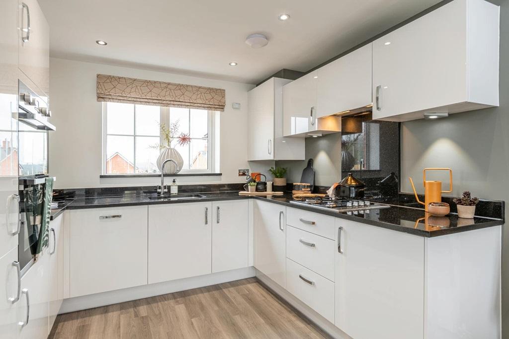 With a spacious kitchen looking out to the...