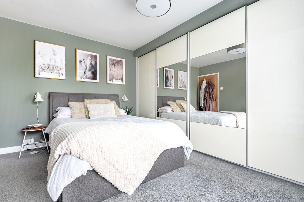 Bedroom 1 with fitted wardrobes and sliding doors