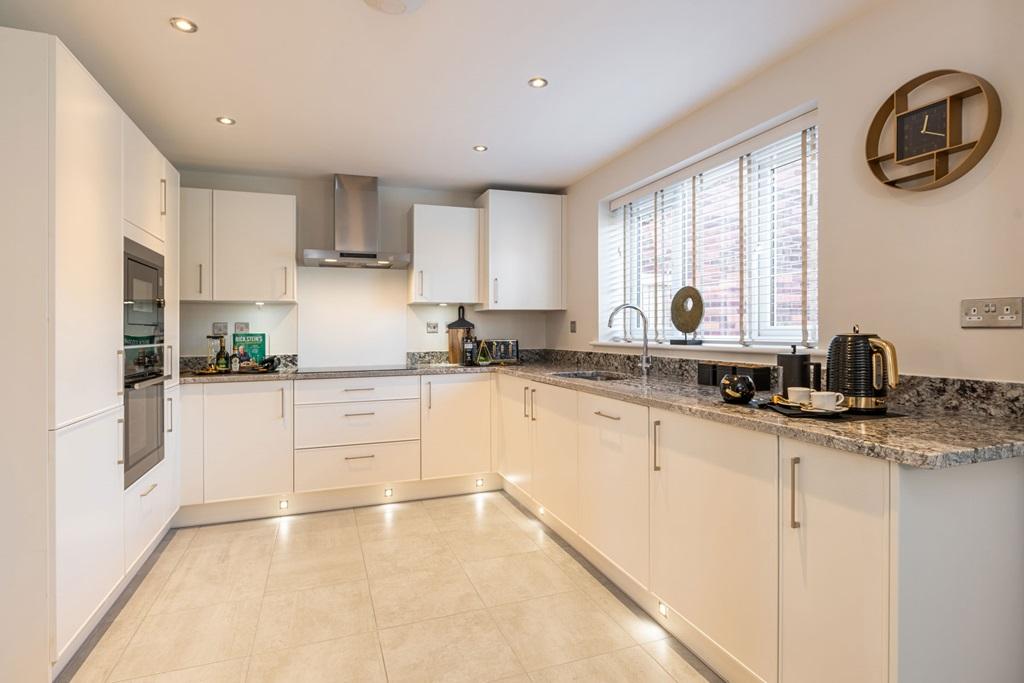 The kitchen includes ample storage