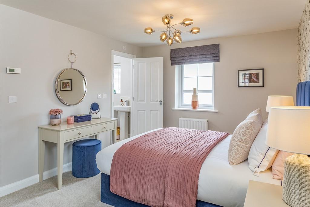 Main bedroom with en suite bathroom in the Alderney 4 bedroom home