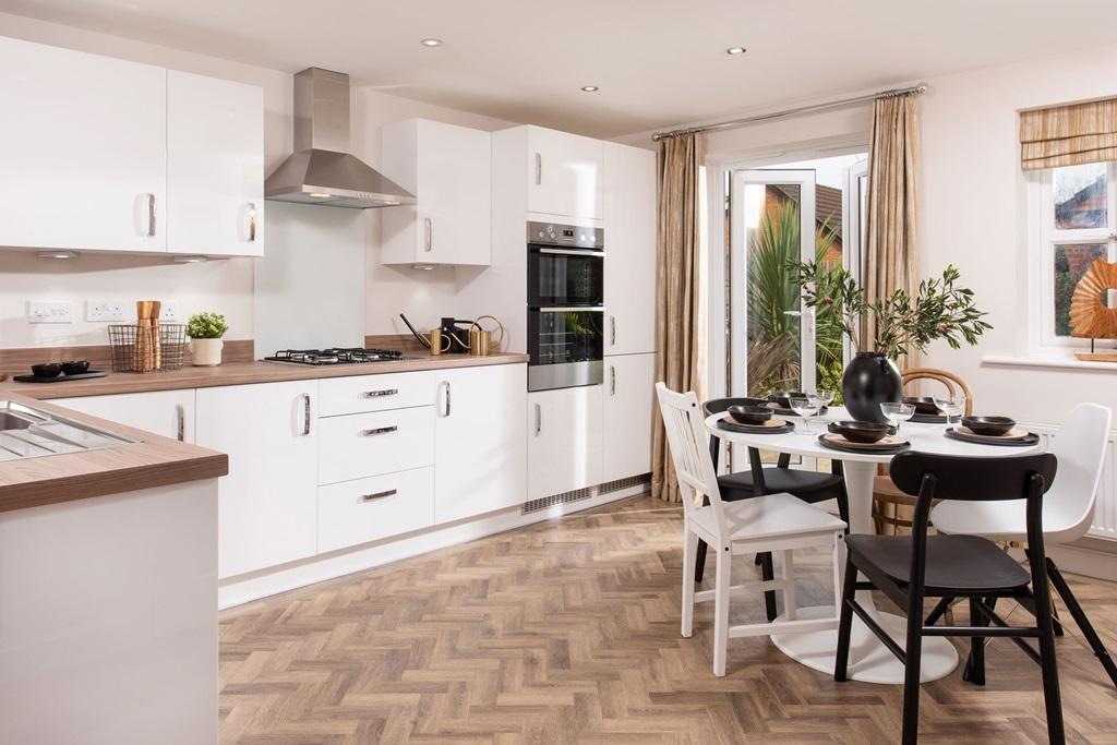Internal shot of kitchen in the hesketh style of home, with french doors leading to garden