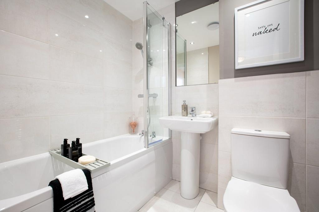 A stylish bathroom with shower over the bath