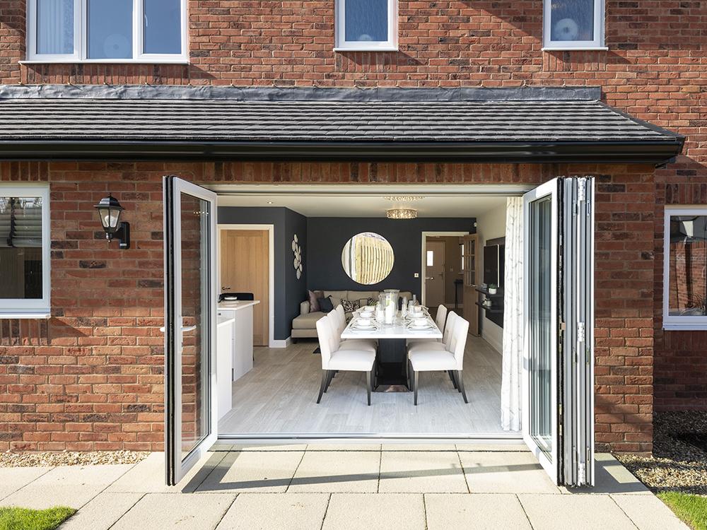 Bi fold doors leading to a rear turfed garden