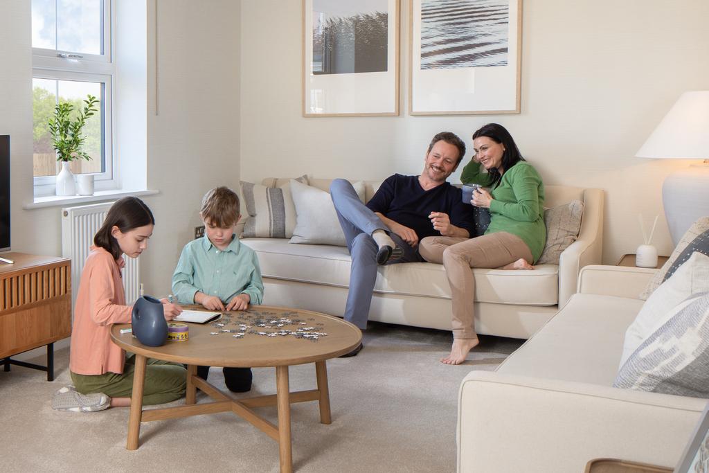 Spacious lounge with family sat around, hadley, 3 bed house type