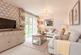 A blank canvas living room with double doors out to the garden