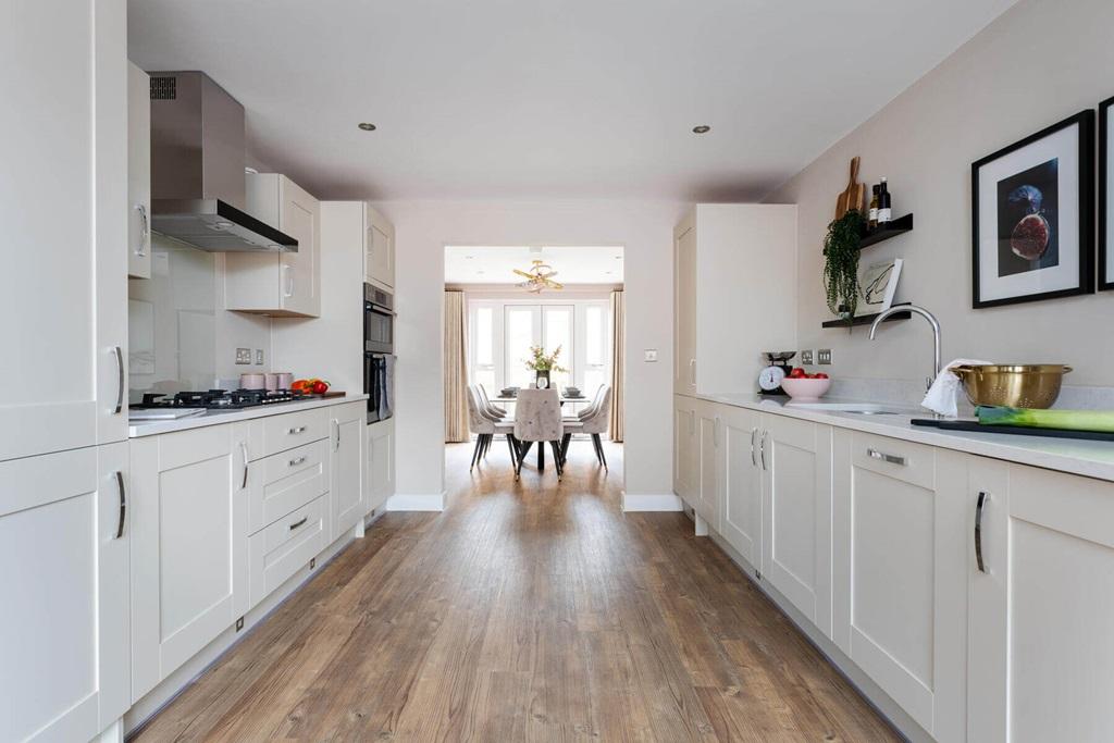 The kitchen leads to a dining area, leading through double doors to the garden