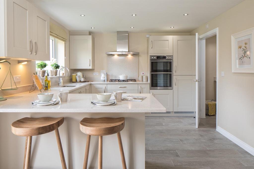 Offering a bright and open kitchen and dining area leads to a utility area