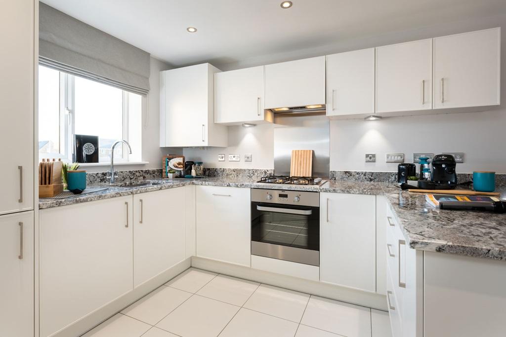 The modern kitchen includes ample storage