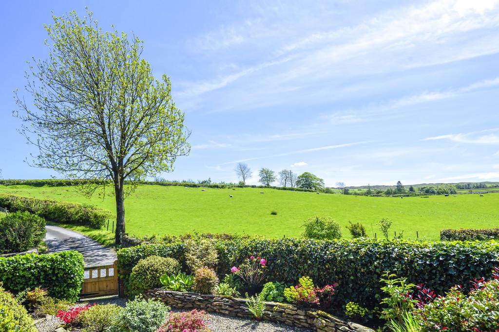 Looking across front garden to open countryside