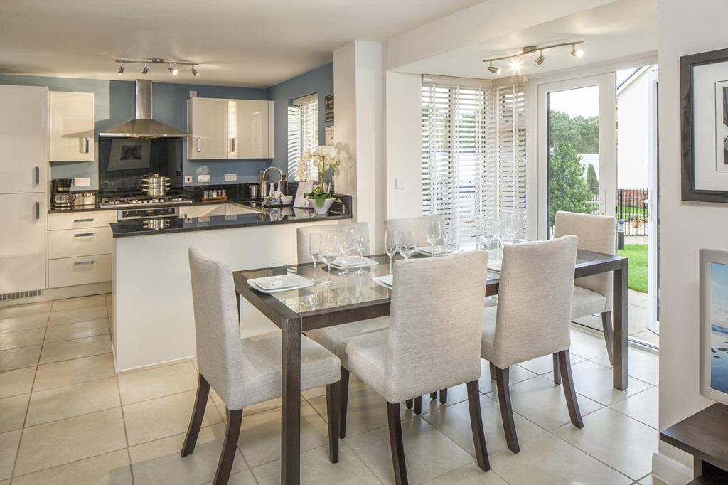 Open-plan kitchen with family/dining areas and glazed-bay with French doors