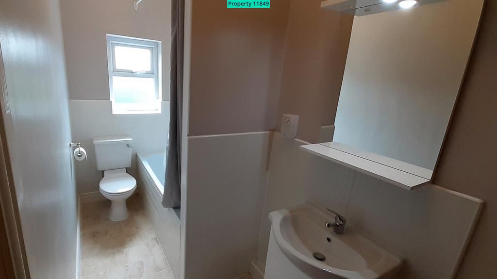 Bathroom includes bath with overhead shower