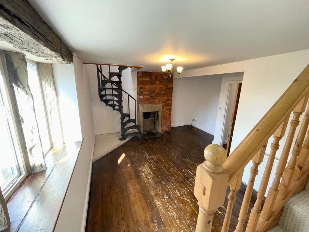 Lounge room with featured spiral staircase