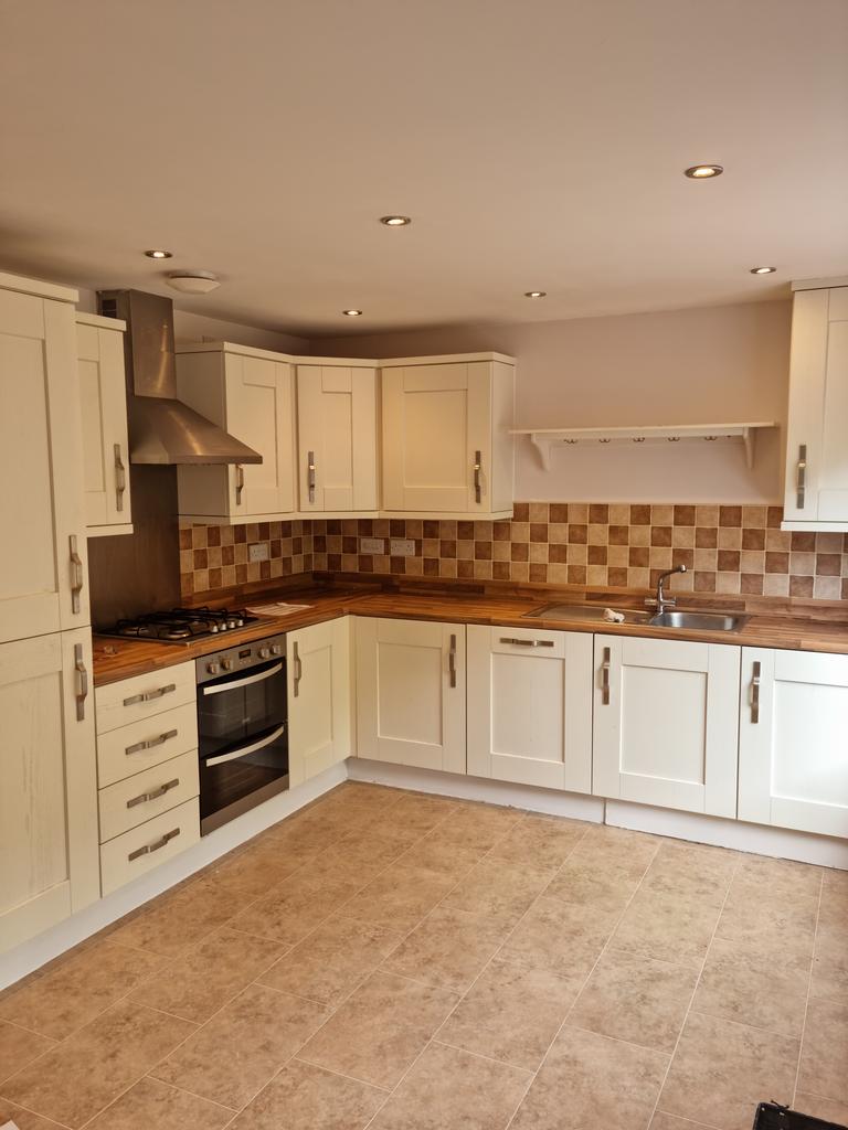 Kitchen with integrated washing machine, fridge...