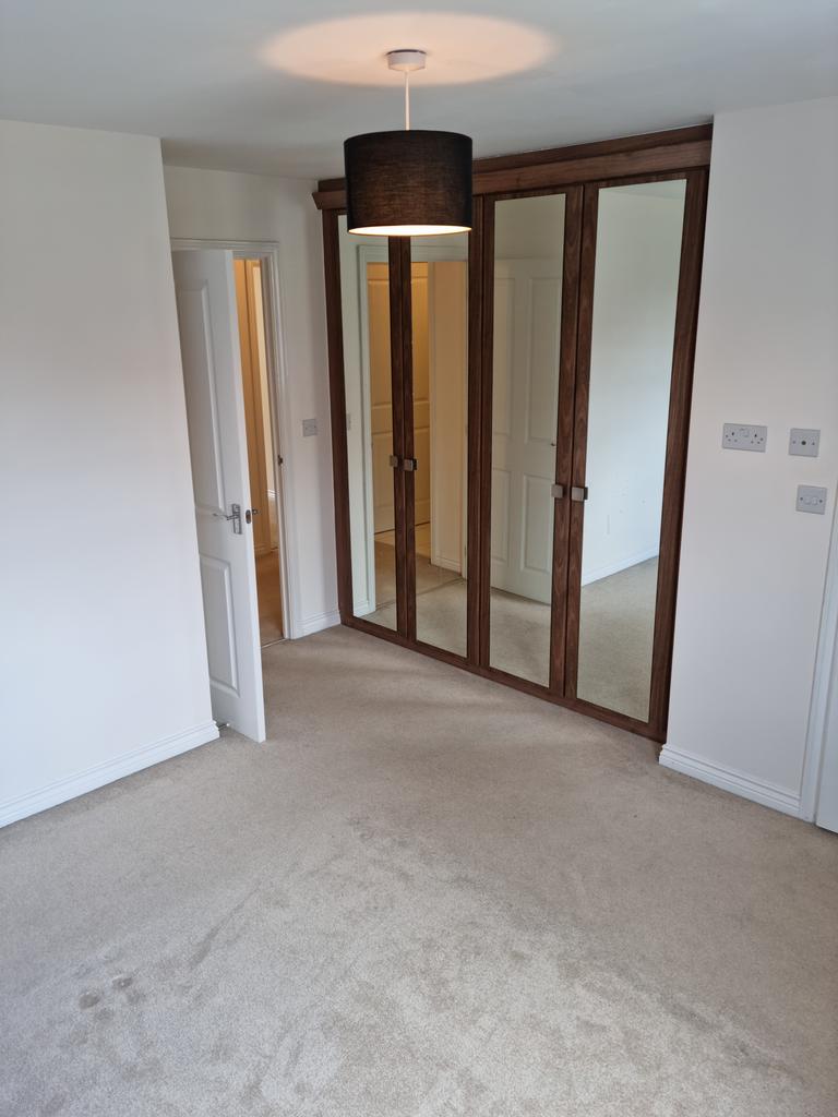 Master bedroom with built in mirrored wardrobes