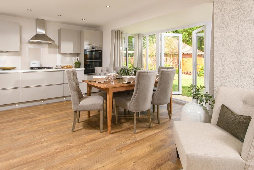 Open plan kitchen with integrated appliances, dining area &amp; family room with French doors leading on