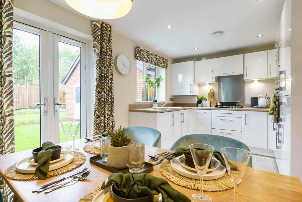 The open plan kitchen/dining area boasts double doors to the garden