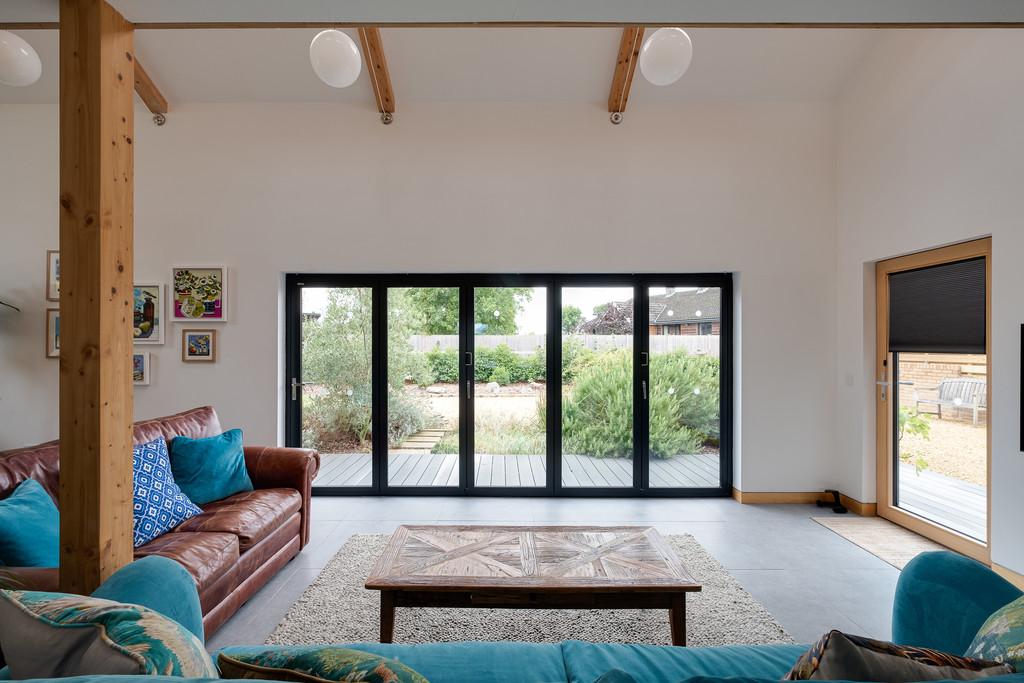 Sitting area with bi-fold doors to Mediterranean g