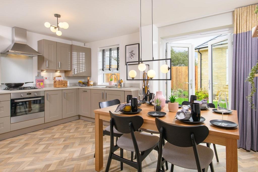 Open-plan kitchen/diner with French doors onto...