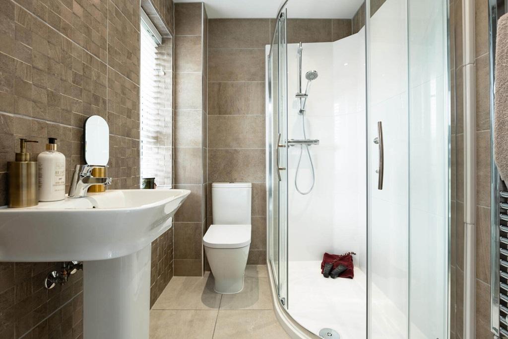 An en suite from the main bedroom creates a...