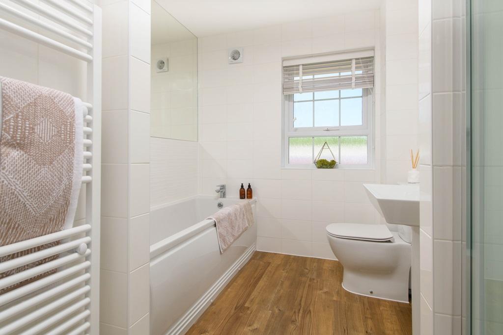 Family bathroom with shower over bath &amp; storage