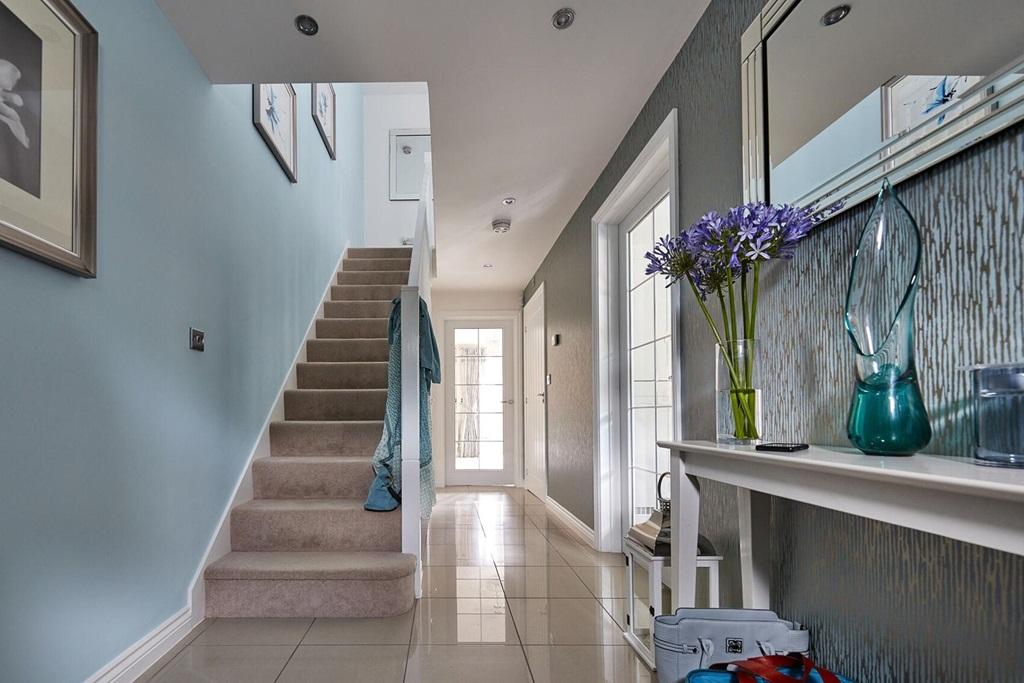 Light and airy hallway leads down to the living...
