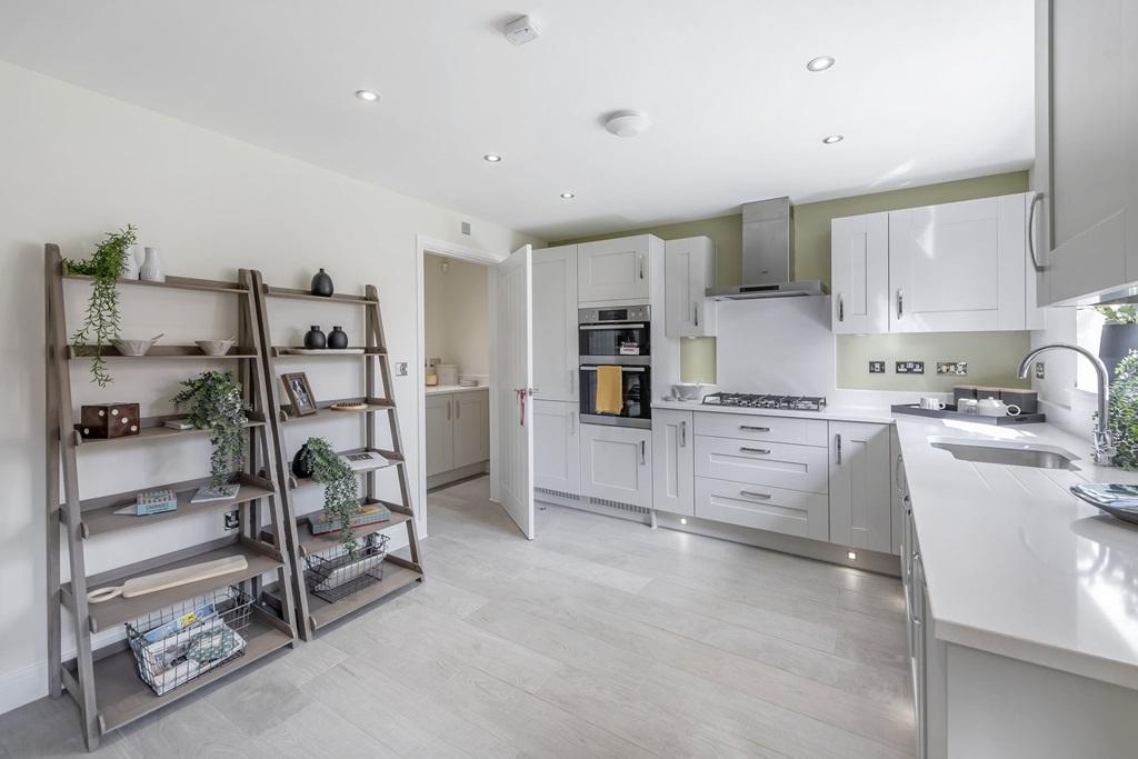 A open plan kitchen and dining area features a...