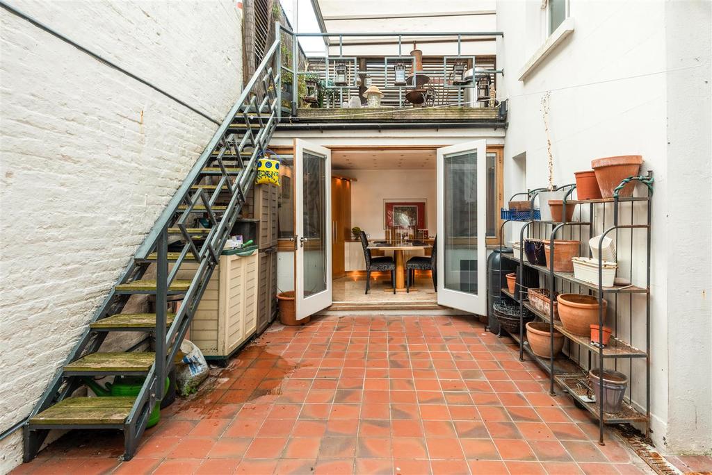 Garden patio looking up to roof terrace.jpg