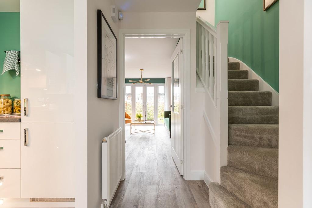 A welcoming hallway opens out to the kitchen...