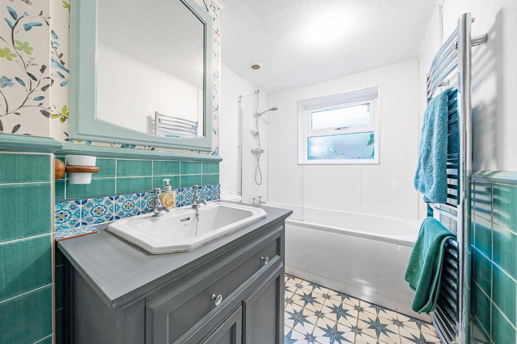Bathroom with separate shower over the bath
