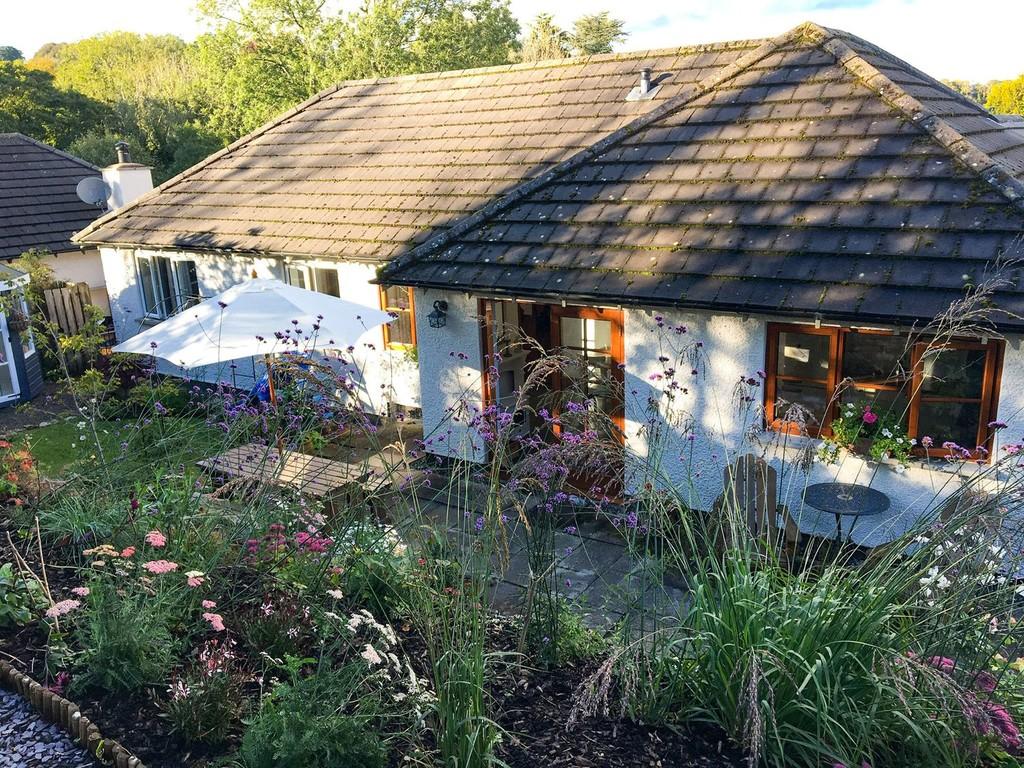 Rear aspect and garden in summer