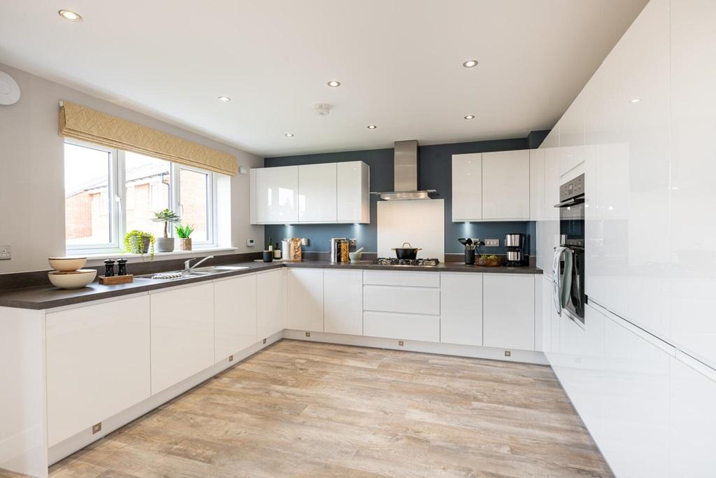 The impressive modern kitchen features ample...