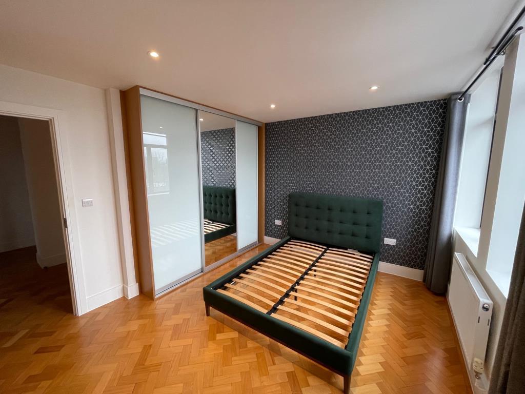 Bedroom with built in sliding wardrobe and parquet