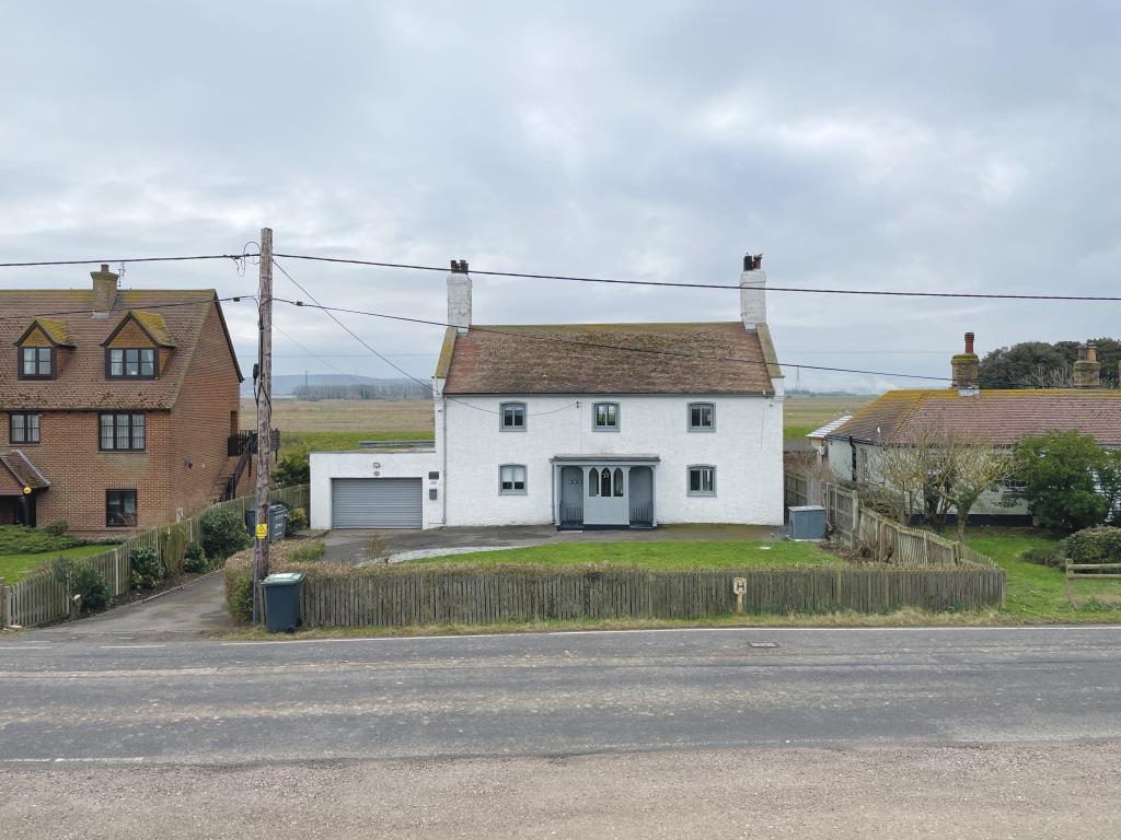 Detached building with garage and views of country