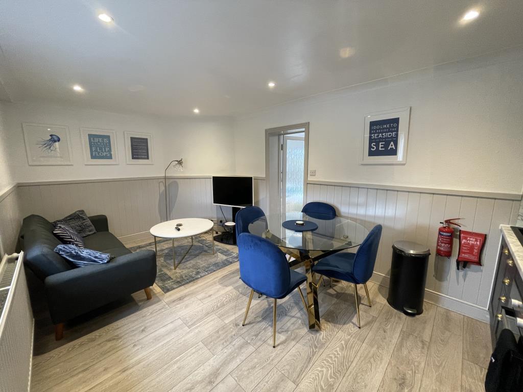 Living room/kitchen with panelled walls