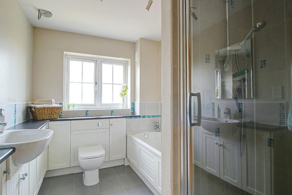 Family bathroom with shower and bathtub