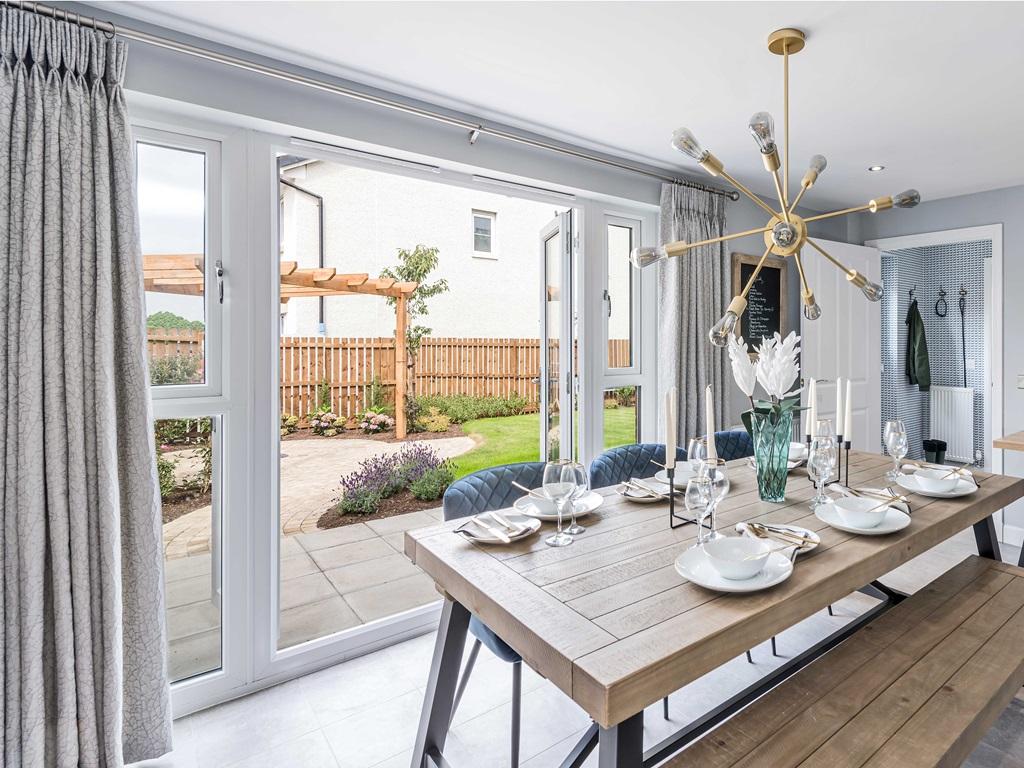 Dining area with doors opening to back garden...