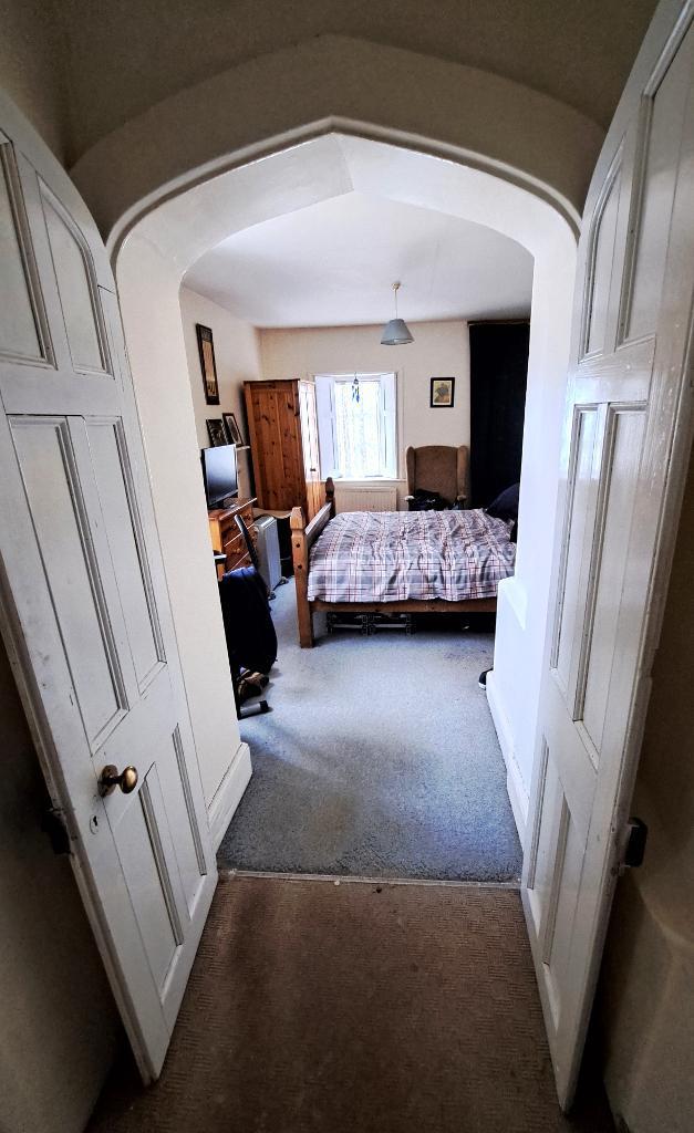 Arched doorway to Bedroom