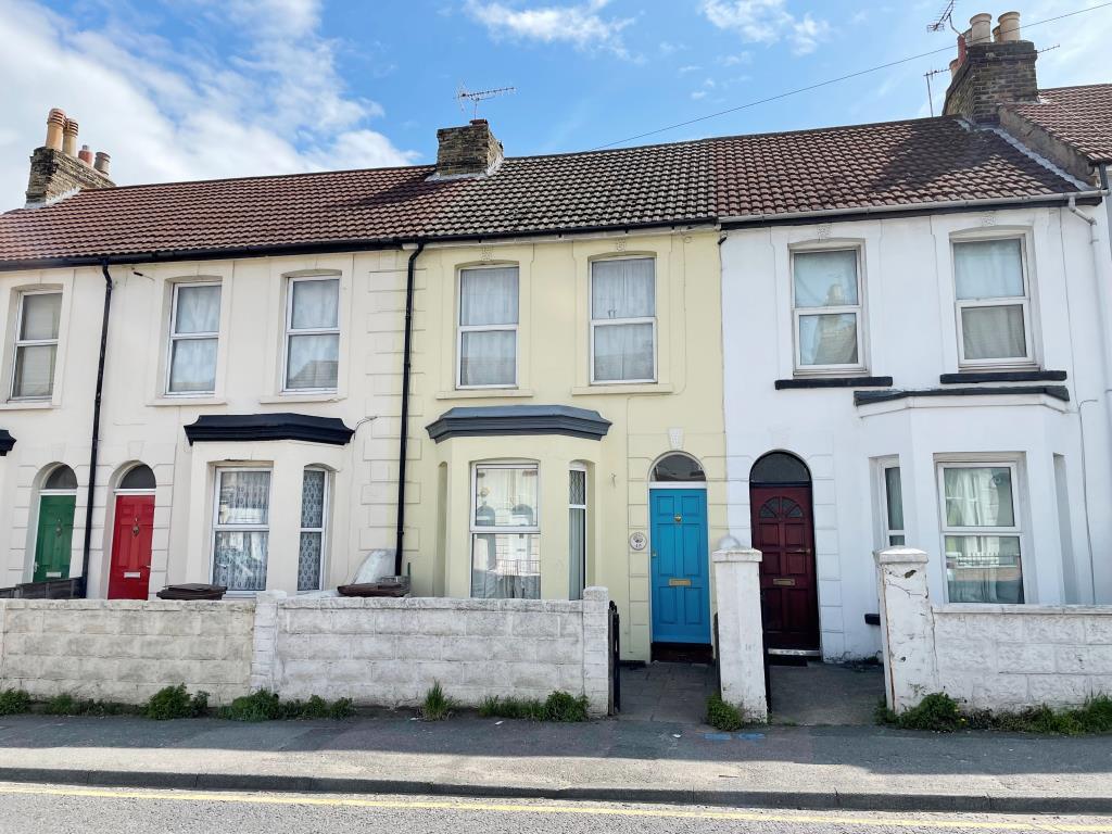 Cream painted mid terraced house, with a blue door