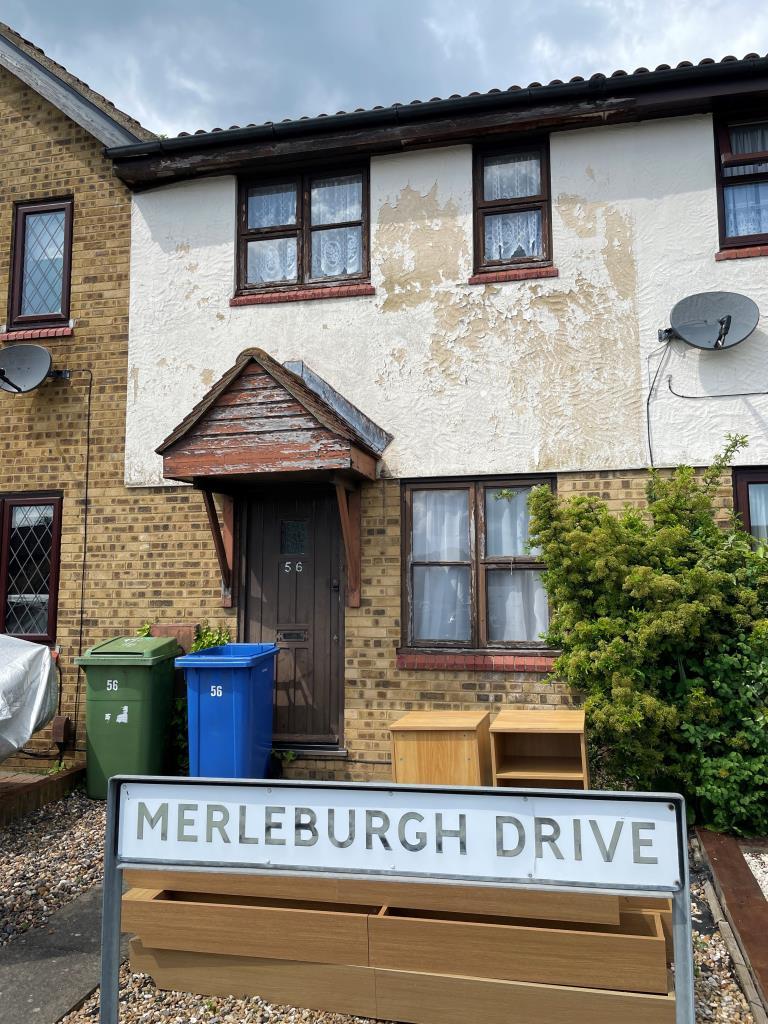 Front of mid terraced property with garden