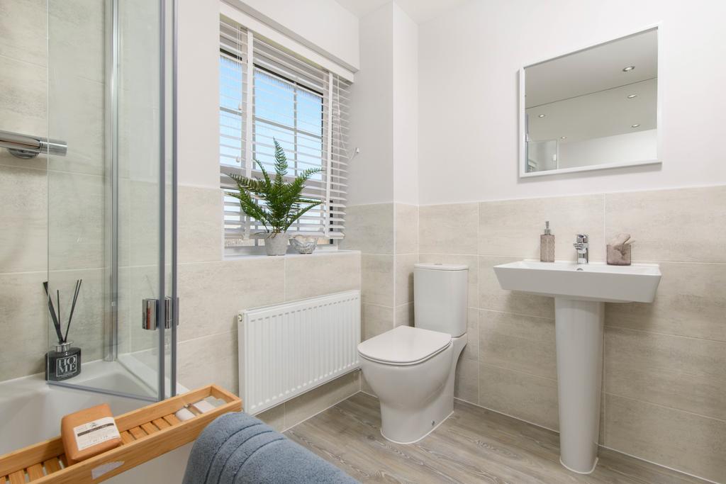 Family bathroom with shower over bath and 2...